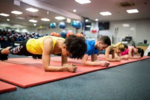 Fit people working out in fitness class